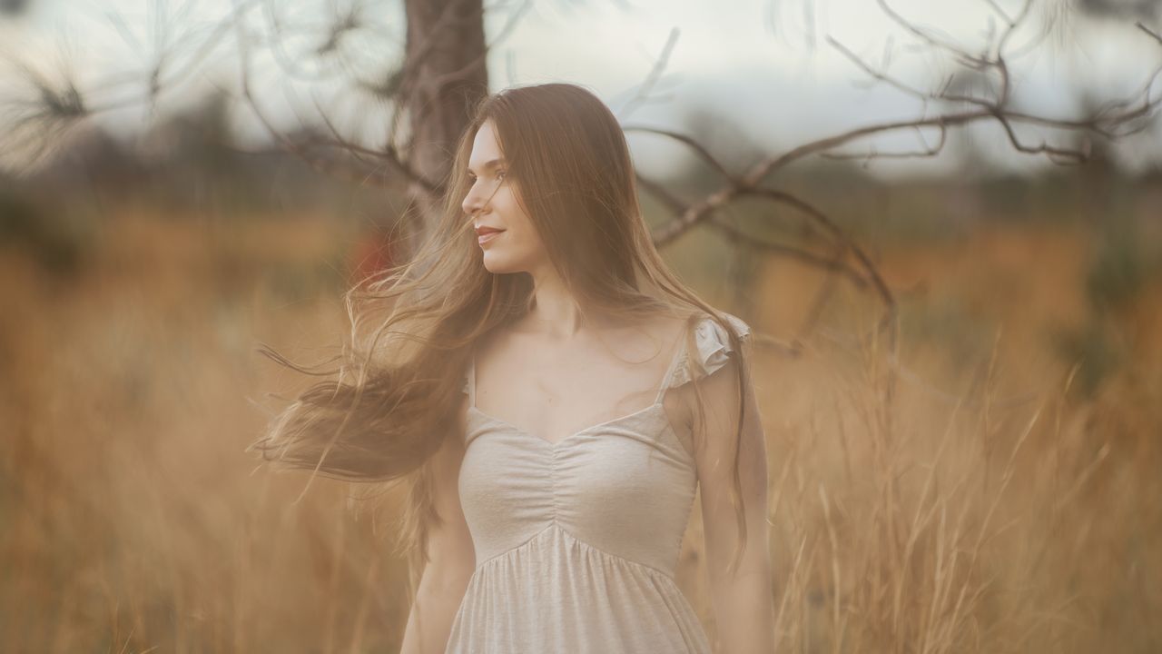 Crafting Captivating Headlines: Your awesome post title goes here A woman in a white dress enjoys the calm of a rural field.